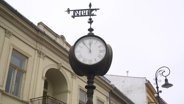 Old clock from 1914 with a building in the background on the main street of Kosice city in Slovakia