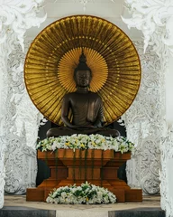 Zelfklevend Fotobehang Historisch monument Beautiful Buddha idol statue in Wat Rong Khun White Temple, Chiang Rai, Thailand