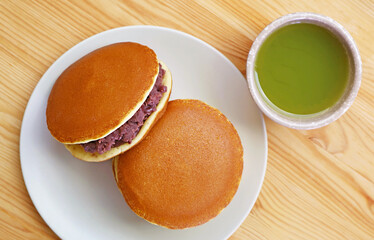 Top View of Delectable Dorayaki with a Cup of Hot Matcha Green Tea