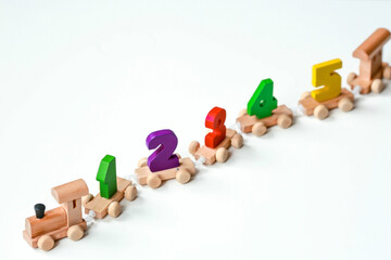 Wooden train with numbers on a white isolated background. Children's educational logic toys are used in Montessori games for development.