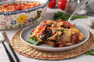 Traditional Italian dish Parmigiana is an appetizer made from baked eggplant, cheese, garlic and tomato sauce