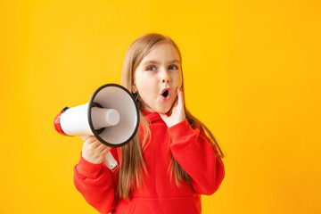 Portrait of a child girl screaming into a megaphone, color background