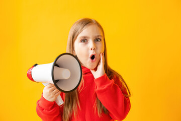 Portrait of a child girl screaming into a megaphone, color background