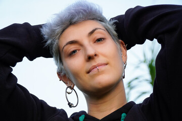 Non binary transgender one person looking at camera outdoor. Gay pride's day
