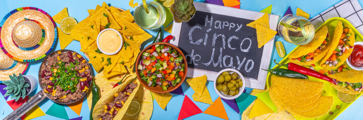 Cinco de mayo party food. Mexican holiday Cinco de mayo traditional dishes, snacks, tortilla corn chips, nachos, tacos, salsa, sauces. Friends and family feast background top view copy space