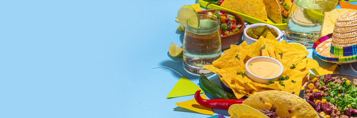 Cinco de mayo party food. Mexican holiday Cinco de mayo traditional dishes, snacks, tortilla corn chips, nachos, tacos, salsa, sauces. Friends and family feast background top view copy space