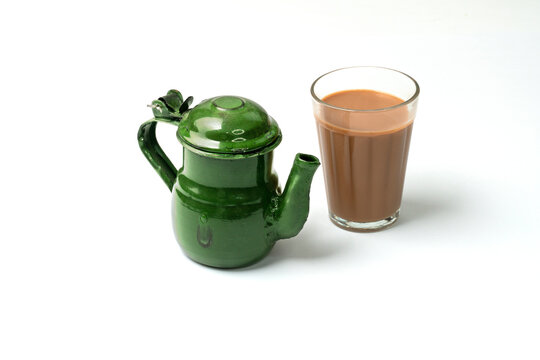 Karak Milk Chai with chanak (tea pot) famous indian tea on white background 