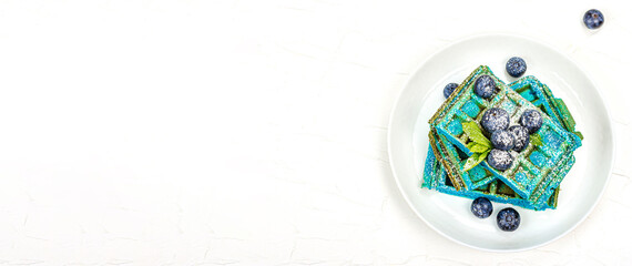 Obraz na płótnie Canvas Homemade Belgium Waffles with blueberries. Gluten-free blue dessert, fresh fruits and mint
