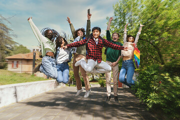 Multiracial Teenagers Jumping in Park - Six happy multiracial teenagers, including Filipino,...