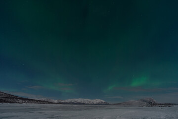 Fototapeta na wymiar northern lights aurora borealis lapland night landscape 