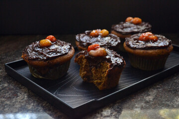 Vegan coffee cupcakes with chocolate frosting and acerola cherries