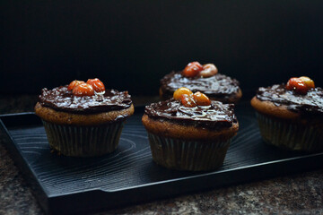 Vegan coffee cupcakes with chocolate frosting and acerola cherries