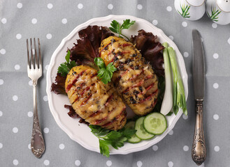 Baked potatoes stuffed with sausage and cheese on a white plate, Closeup, View from above