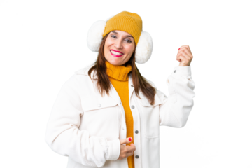 Middle age woman wearing winter muffs over isolated chroma key background making guitar gesture