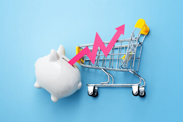 Inflation and consumer price increasing concept with red graph rising out of piggy bank with...