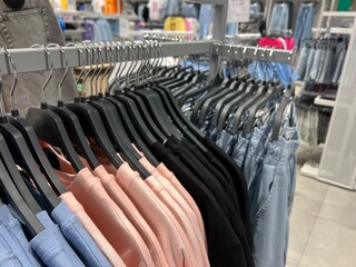 Store clothes on hangers. Large assortment of colorful clothes.
