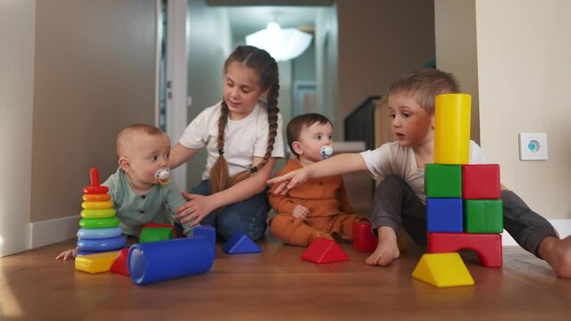 baby boy play kids a girl and in kindergarten. group of children playing toys in kindergarten on the floor. friendly family preschool education lifestyle indoor concept. baby play toddler home