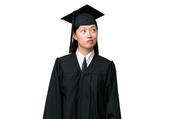 Young university graduate Asian woman over isolated background and looking up