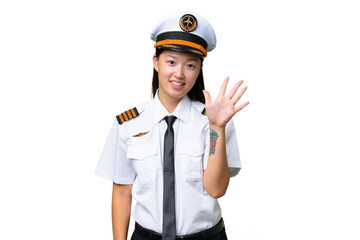 Airplane pilot Asian woman over isolated background counting five with fingers