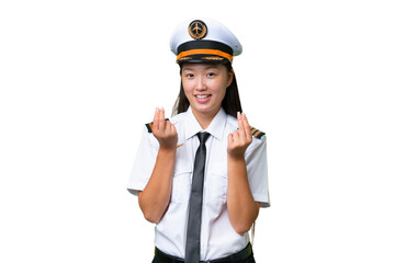 Airplane pilot Asian woman over isolated background making money gesture