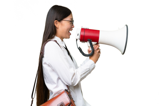 Young Asian business woman over isolated background shouting through a megaphone