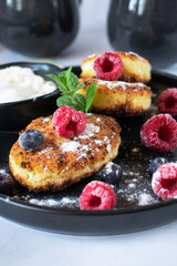 Delicious cheesecakes with berries and sour cream. Delicious breakfast. Morning