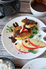 Delicious cheesecakes with berries and sour cream. Delicious breakfast. Morning