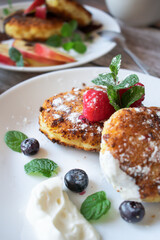 Delicious cheesecakes with berries and sour cream. Delicious breakfast. Morning