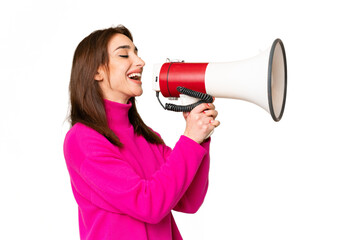 Young caucasian woman over isolated chroma key background shouting through a megaphone