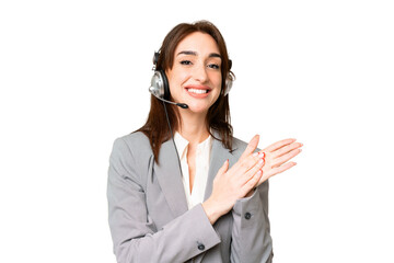 Telemarketer caucasian woman working with a headset over isolated chroma key background applauding...