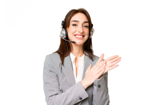 Telemarketer caucasian woman working with a headset over isolated chroma key background applauding after presentation in a conference