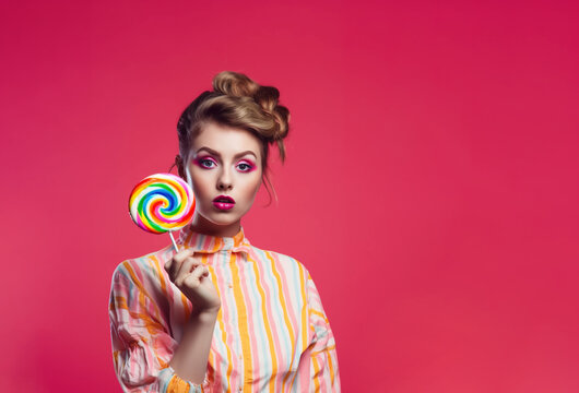 Studio shot of Beautiful young woman holding lollipop in hand against pink red background, Generative Ai illustration