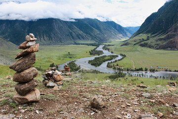 Stone pyramid in river valley Chulyshman. Natural mountain landscape Republic Altai, Russia, summer day. tourist place