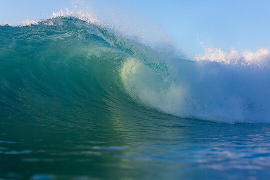 perfect surfing wave breaking on a reef