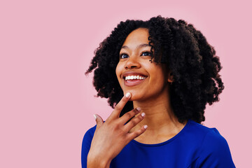 close up of an african american woman with afro hair with a finger in her chin