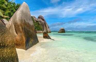Idyllic tropical beach with amazing rock formations and turquoise water on sunny day in summer