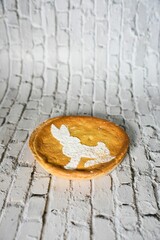 Vertical shot of an Easter pie with a bunny on it on a white surface