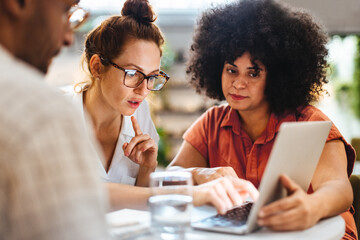 Remote team discussing a business project using a laptop