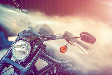 Summer motorcycle wash. Car cleaning with high pressure water. - 595000442