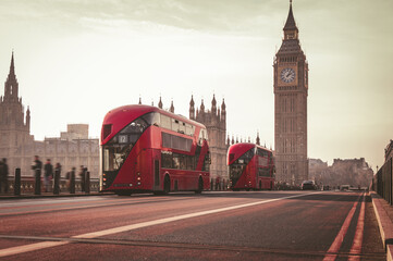 Red London Bus on the Westminster Bridge and Big Ben Tower in the background.