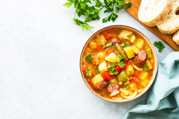 Minestrone soup, italian vegetable soup with smoked sausages, Top view. - obrazy, fototapety, plakaty