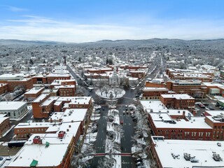 Fototapeta premium Aerial view of residential buildings and roads covered in the snow in Keene, New Hampshire