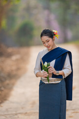 Beautiful Asian girl of rural villagers wearing the traditional classical Thai dress Northern of...