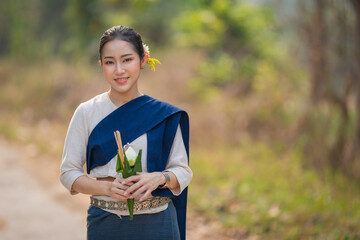 Beautiful Asian girl of rural villagers wearing the traditional classical Thai dress Northern of...
