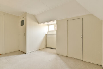an empty room with white walls and beige carpet, there is no one person in the room to be seen