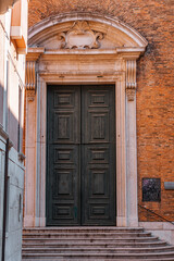 Intricately carved wooden door in Venice with decorative engravings
