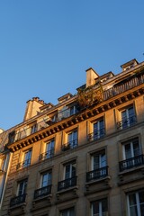Fototapeta na wymiar Apartment building with balconies lit in soft evening sunlight