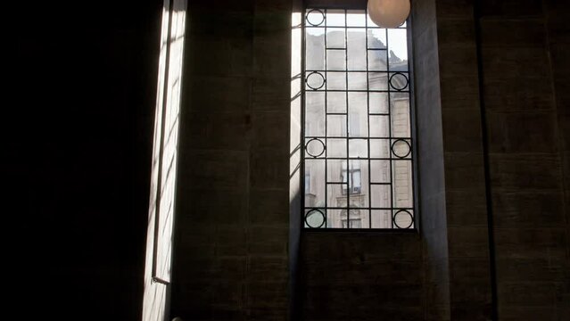 A beautiful shot of a church window where heavenly light comes through