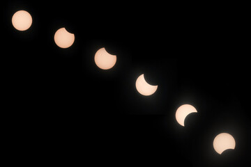 Solar eclipse hibrida phases on April 20, 2023. Cosmos with moon and sun in total and partial solar eclipse and stars.