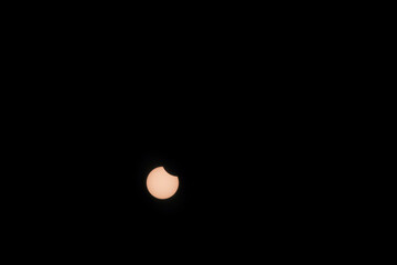 Solar eclipse hibrida phases on April 20, 2023. Cosmos with moon and sun in total and partial solar eclipse and stars.